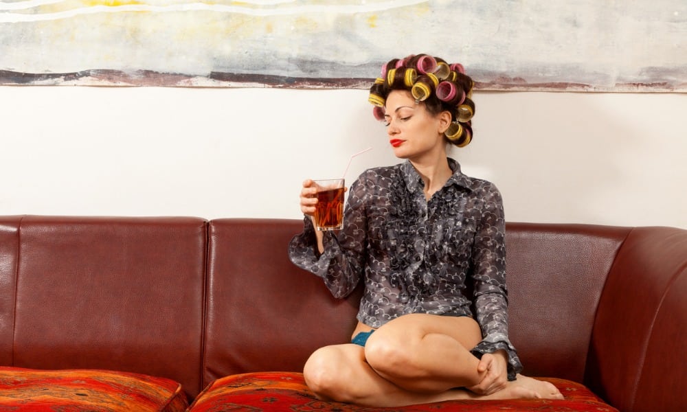 sexy girl drinking a drink on the couch picture id534217769